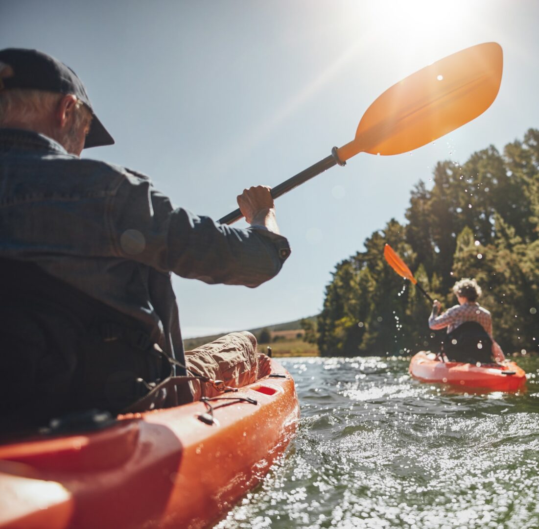 Two people in a canoe paddle through the water.