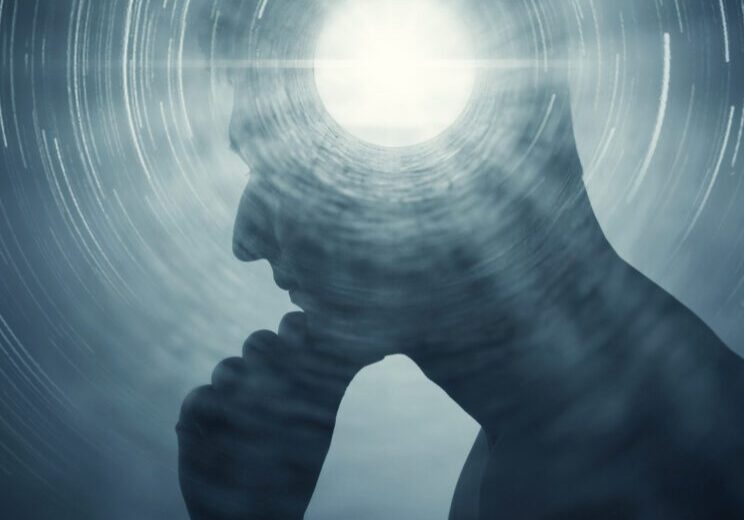 A silhouette of a man with rays of light emanating from the brain as a symbol of the power of thinking. Halls of consciousness. Concept on the topic of psychiatry, psychology, religion, science, spiritual growth.