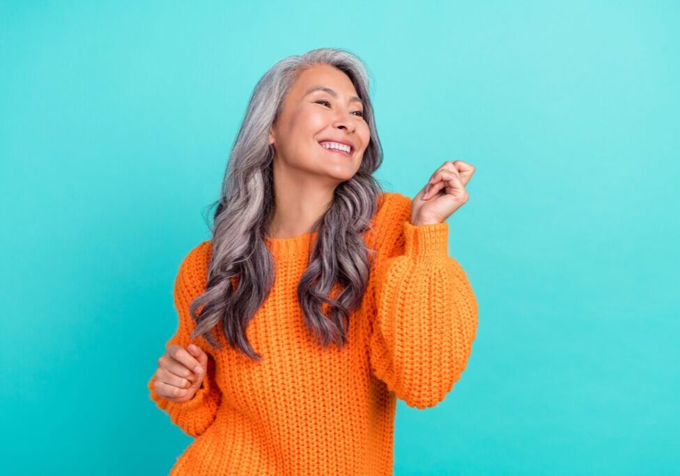 Profile side photo of mature cheerful pretty lady have fun clubber look empty space isolated over turquoise color background.